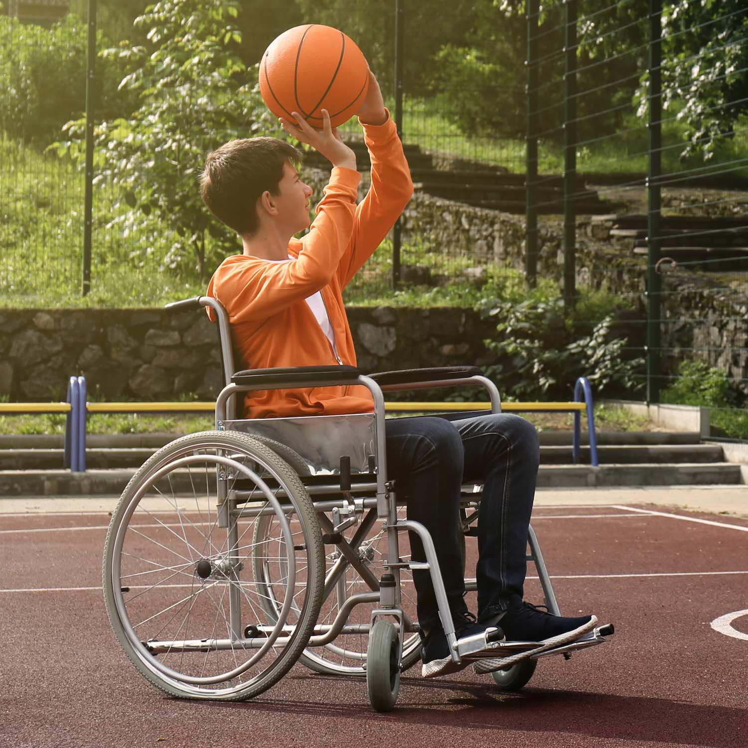 Disabled,Teenage,Boy,In,Wheelchair,Playing,Basketball,On,Outdoor,Court location-vente-materiel-medical-pharmacie-centrale-boonefeas-lorthois-courrieres-oignies-harnes