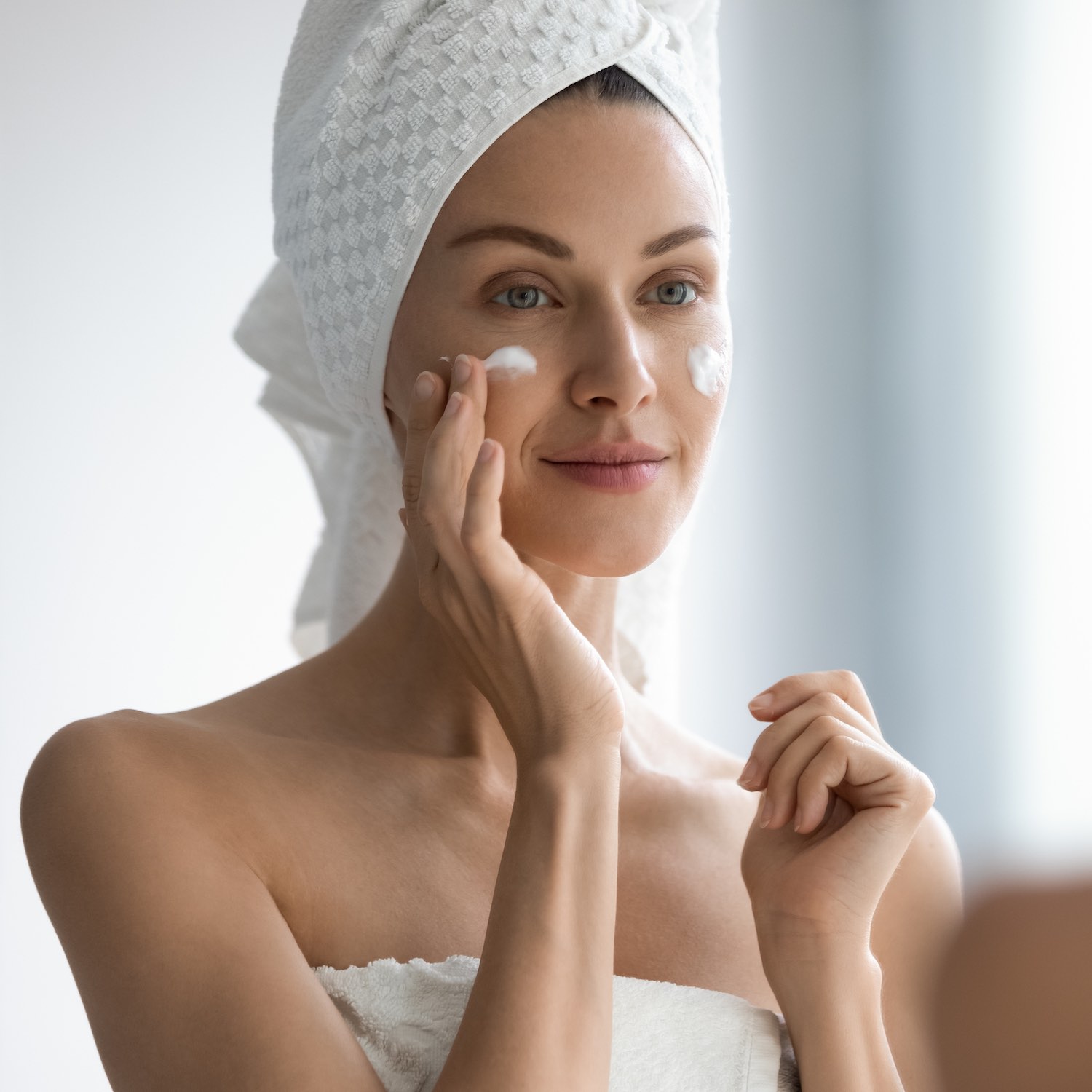 Attractive,Young,Adult,Woman,Apply,Facial,Cream,Look,In,Mirror, location-vente-materiel-medical-pharmacie-centrale-boonefeas-lorthois-courrieres-oignies-harnes